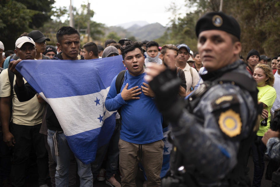 FILE - In this Jan. 16, 2020 file photo, Honduran migrants hoping to reach the U.S. border are stopped by Guatemalan police near Agua Caliente, Guatemala, on the border with Honduras. The reasons Hondurans continue to flee their country have been well documented: pervasive violence, deep-seated corruption, lack of jobs and widespread destruction from two major hurricanes that struck the region in November 2020. (AP Photo/Santiago Billy, File)