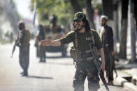 Taliban fighters stand guard at the explosion site, near a mosque, in Kabul, Afghanistan, Friday, Sept. 23, 2022. An explosion went off near a mosque in Afghanistan's capital of Kabul on Friday, with police confirming casualties. A column of black smoke rose into the sky and shots rang out several minutes after the blast in the city's diplomatic quarter. (AP Photo/Ebrahim Noroozi)