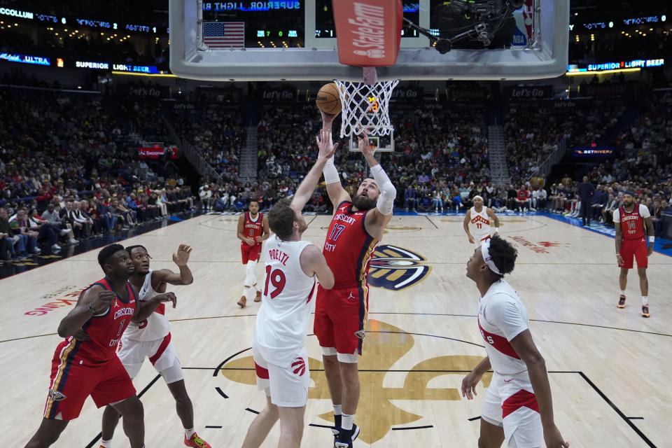 New Orleans Pelicans center Jonas Valanciunas (17) shoots against Toronto Raptors center Jakob Poeltl (19) in the first half of an NBA basketball game in New Orleans, Monday, Feb. 5, 2024. (AP Photo/Gerald Herbert)