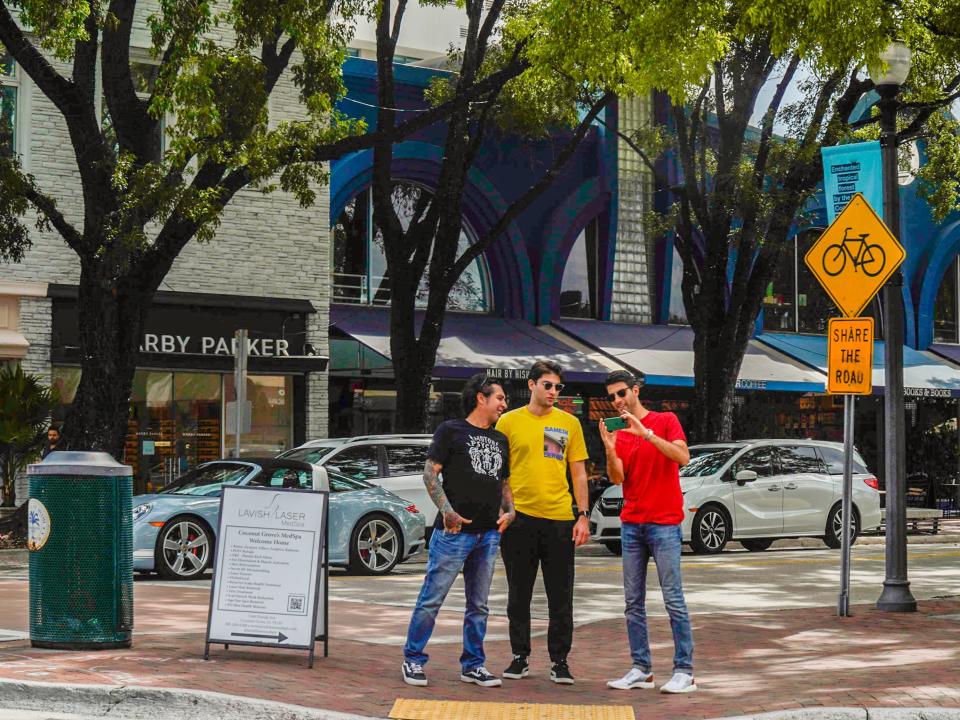 People gather in front of shops in Coconut Grove