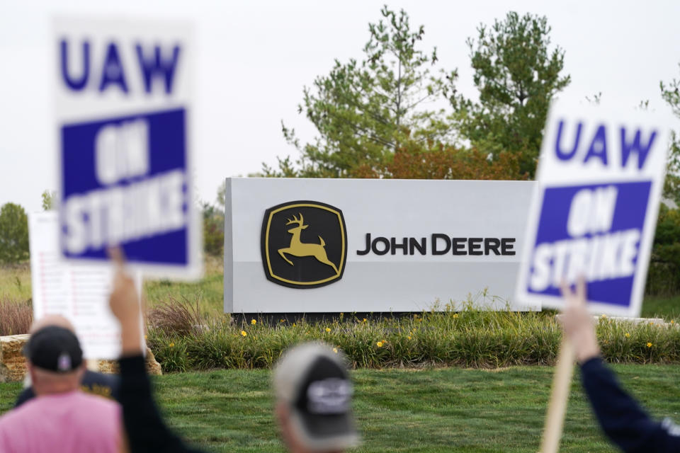 FILE - Members of the United Auto Workers strike outside of a John Deere plant, Wednesday, Oct. 20, 2021, in Ankeny, Iowa. The farm equipment manufacturer reached a tentative labor agreement Saturday, Oct. 30, with the United Auto Workers union. But a UAW strike that began Oct. 14 will continue -- and details of the proposed contract will not be released -- while workers study the terms of the agreement in advance of a vote. (AP Photo/Charlie Neibergall, File)