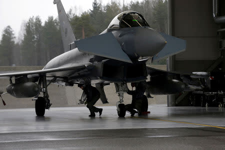 FILE PHOTO: German Air Force technicians inspect Eurofighter Typhoon during the air policing scramble in Amari air base, Estonia, March 2, 2017. REUTERS/Ints Kalnins/File Photo