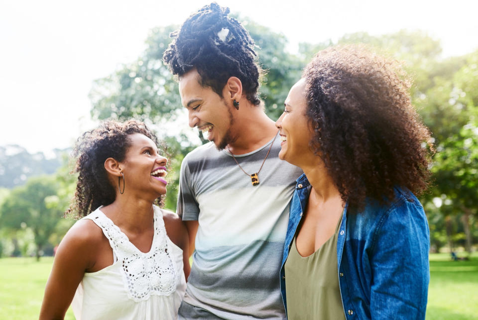 Three people laughing together