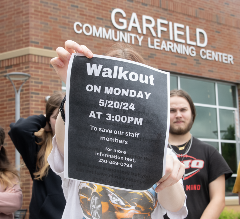Garfield Community Learning Center student Alyssa Feathers, 16, holds a sign Friday for the walkout planned for May 20.
