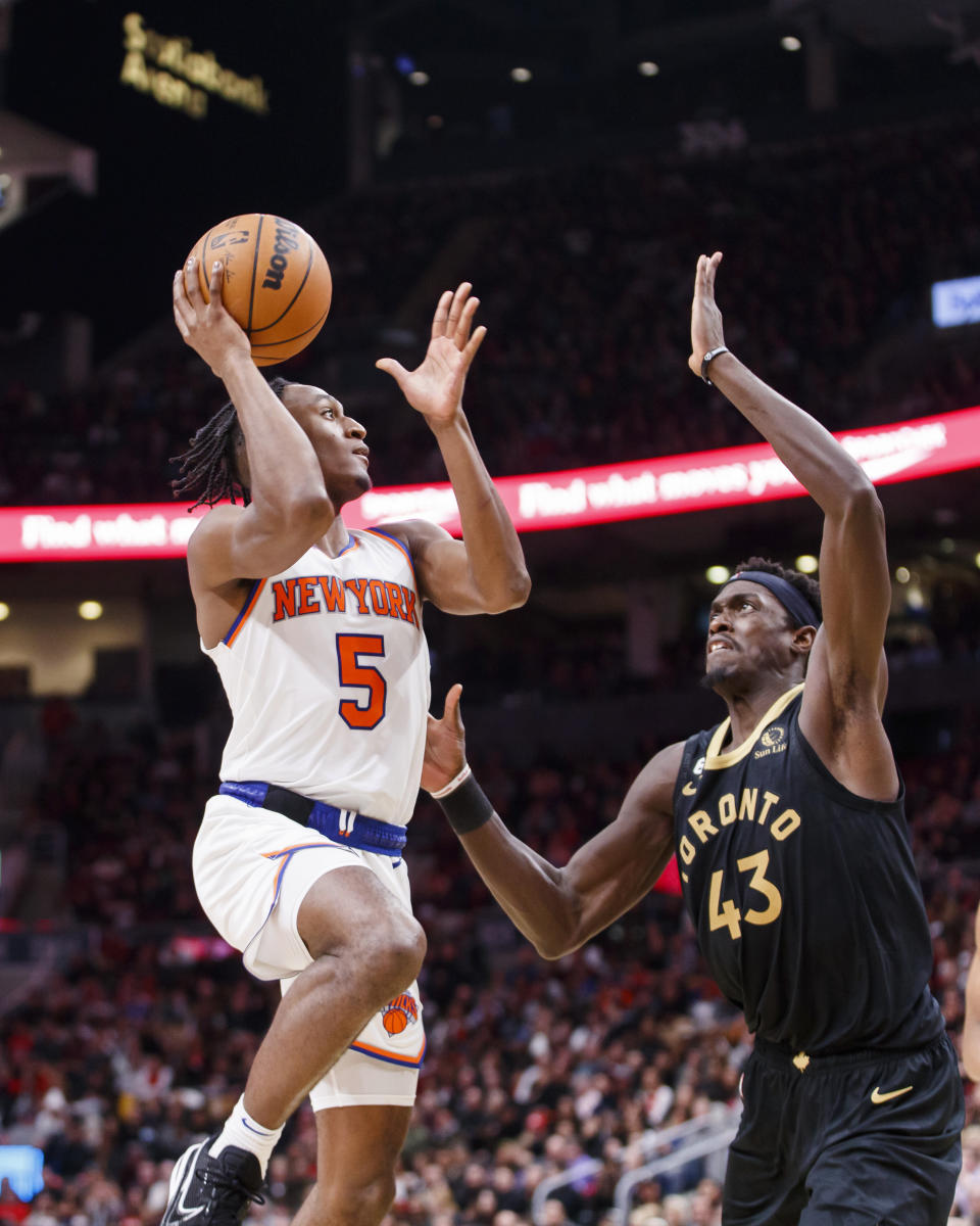New York Knicks guard Immanuel Quickley (5) shoots over Toronto Raptors forward Pascal Siakam (43) during the second half of an NBA basketball game Friday, Jan. 6, 2023, in Toronto. (Cole Burston/The Canadian Press via AP)