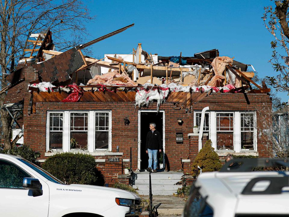 A home owner reacts to tornado damage on December 12, 2021 in Bowling Green, Kentucky (AFP via Getty Images)