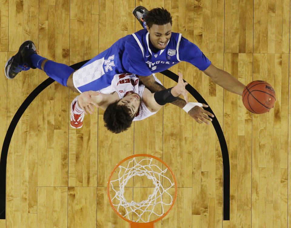 Kentucky guard James Young shoots against Wisconsin forward Frank Kaminsky during the second half of the NCAA Final Four tournament college basketball semifinal game Saturday, April 5, 2014, in Arlington, Texas. (AP Photo/David J. Phillip)