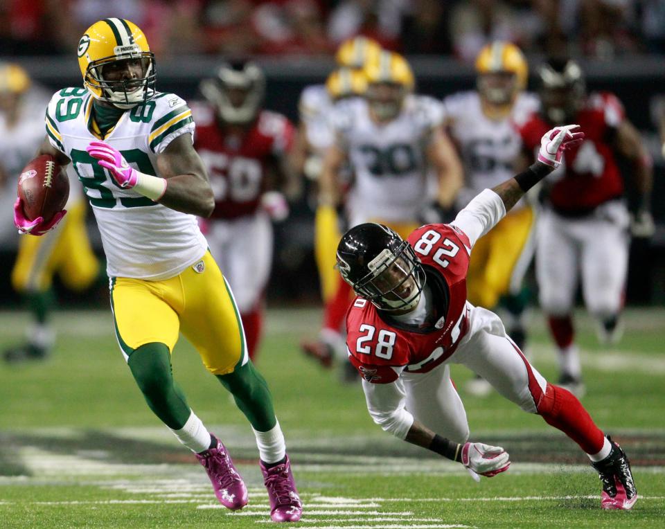 Green Bay Packers wide receiver James Jones scores a touchdown on a 70-yard reception despite the efforts of Atlanta Falcons Thomas DeCoud during the third quarter of their game Sunday, October 9, 2011 at the Georgia Dome in Atlanta, Ga.