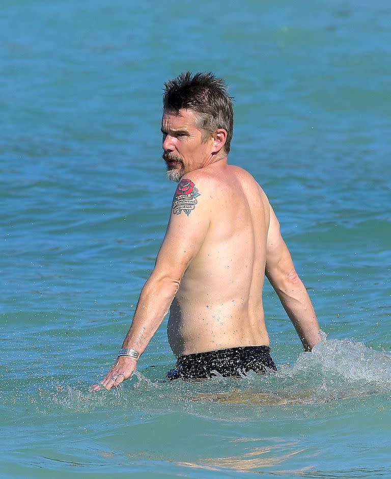 Ethan Hawke shows off his tattoos while bathing in the paradisiacal beaches of St Barts.  Among all his tattoos, a giant rose stands out at the height of his left shoulder