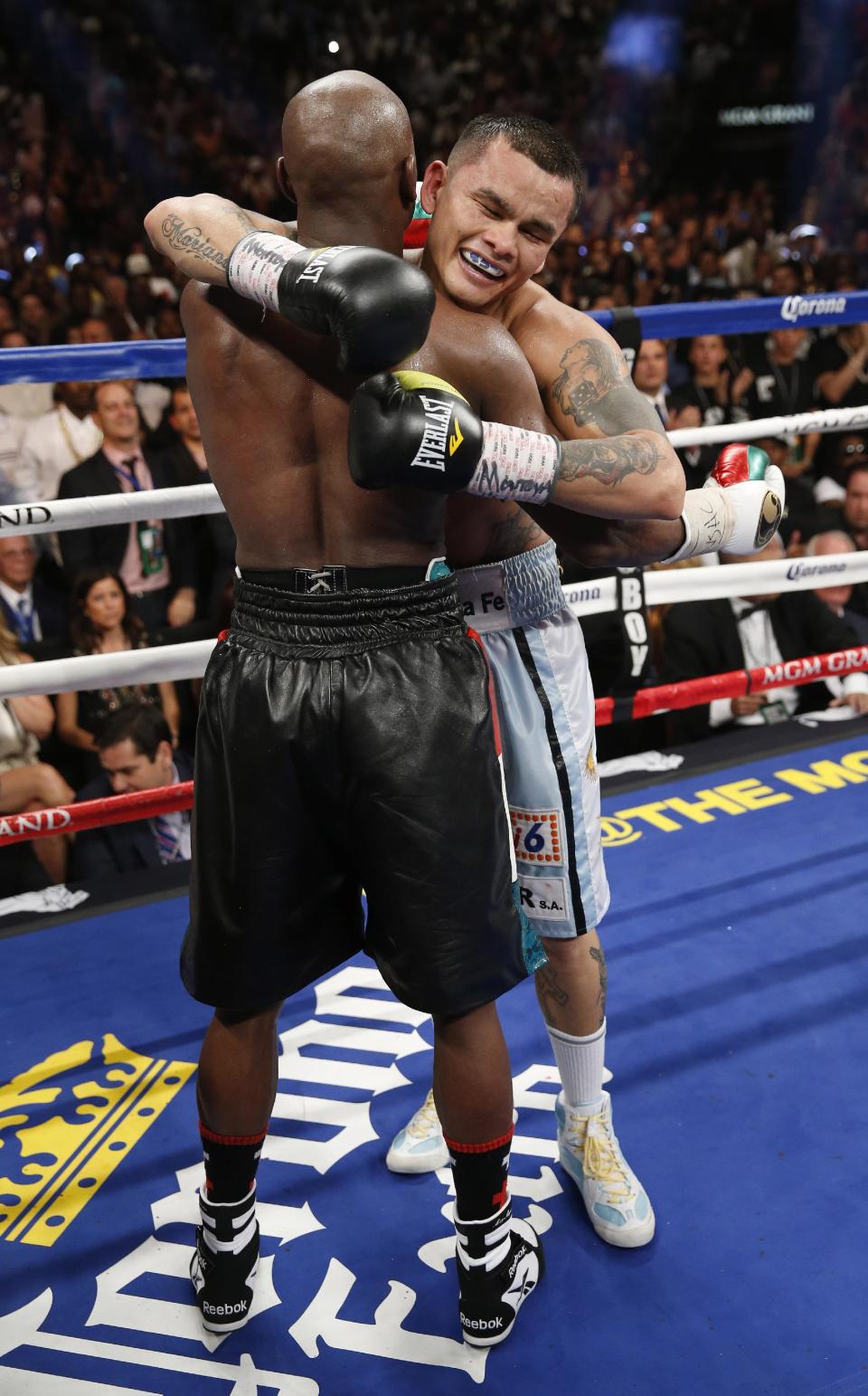 Floyd Mayweather Jr., left, and Marcos Maidana, from Argentina, embrace at the end of their WBC-WBA welterweight title boxing fight Saturday, May 3, 2014, in Las Vegas. Mayweather won by majority decision. (AP Photo/Eric Jamison)