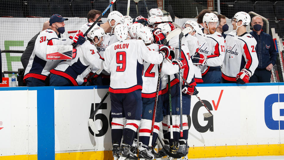 T.J. Oshie is mobbed by teammates after scoring his third goal of the game against the Rangers. (Photo by Jared Silber/NHLI via Getty Images)