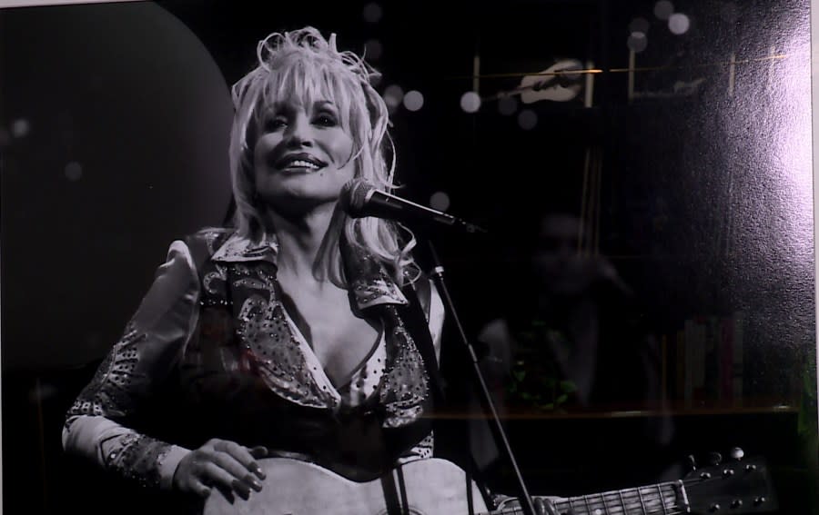 A photo of Dolly Parton performing on the Austin City Limits TV show hangs on a wall inside Austin PBS. (KXAN Photo/Ed Zavala)