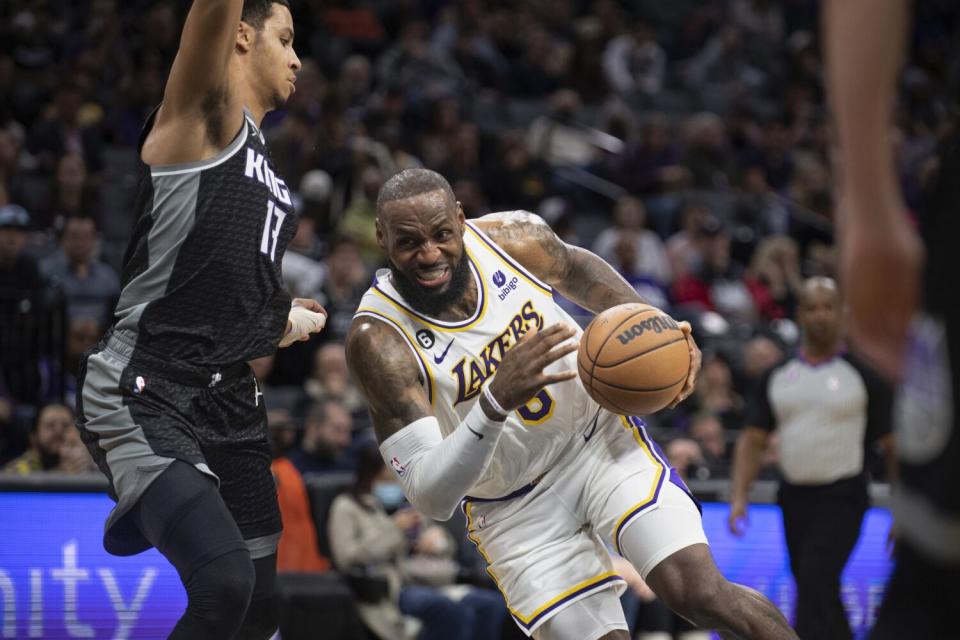 The Lakers' LeBron James drives against the Sacramento Kings' Keegan Murray on Jan. 7, 2023.