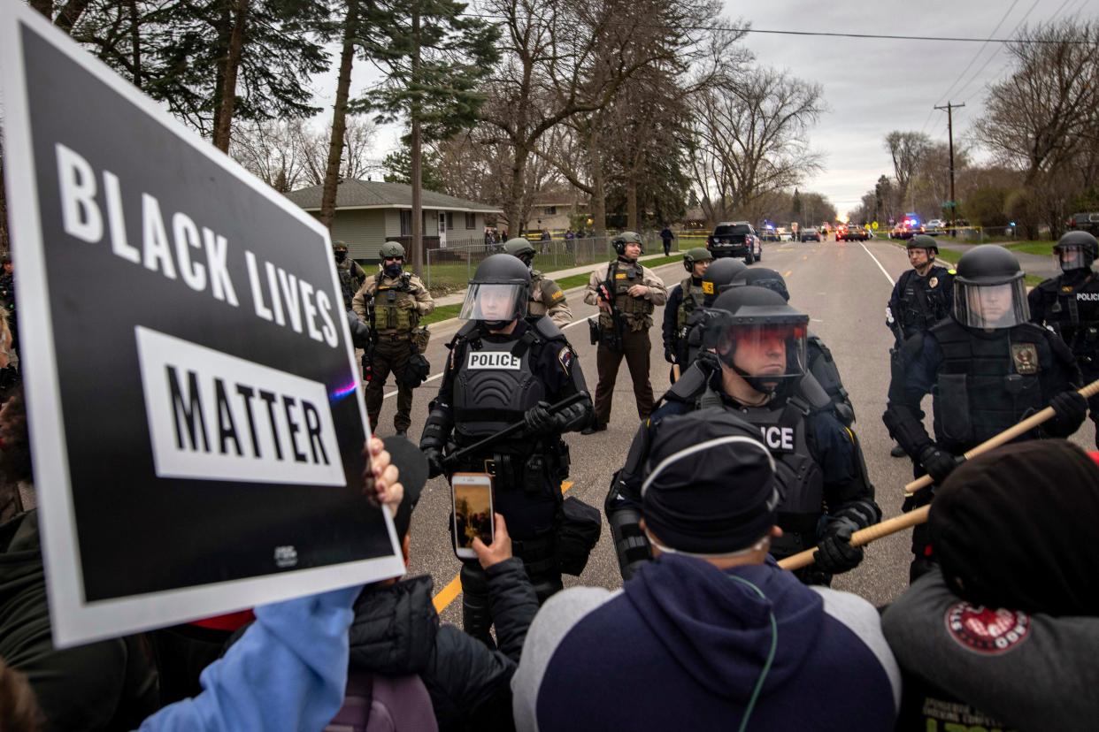 Protesters clash with police, Sunday, April 11, 2021, in Brooklyn Center, Minnesota.