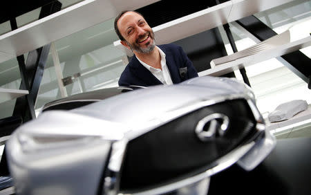 Infiniti, Nissan Motor's premium brand, Executive Design Director Karim Habib smiles behind the brand's car model at its Global Design Center in Atsugi, Japan, April 18, 2018. Picture taken April 18, 2018. REUTERS/Toru Hanai