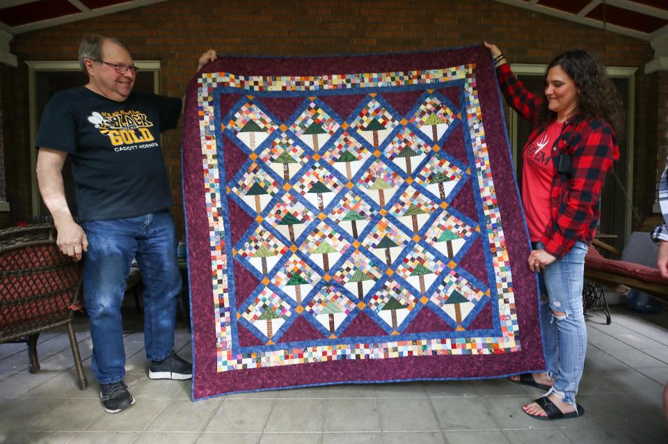 Charlie Sommer holds up a quilt made for him by the wife of the coach of the Cadott High School archery team. It has details that depict the huge sycamore tree in the front yard of the Sommers home on Eastern Parkway.  Over the years, the couple has exchanged several gifts with the team. At some point, the team brought Wendy and Charlie Cadott Hornets gear. One year, Charlie and Wendy went to Churchill Downs and got horseshoes for every member of the Cadott archery team.  The Sommers also had a Louisville Stoneware platter made for the team, which sits in the Cadott High School trophy case alongside a proclamation from former Louisville Mayor Greg Fischer honoring the friendship. In recent years, they’ve put a halt to the gifts. Both the coach and the couple say this isn’t about things. It’s about friendship. Saturday, May 13, 2023
