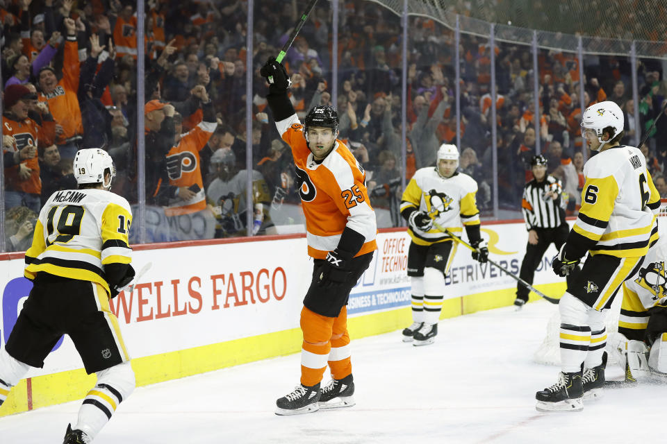 Philadelphia Flyers' James van Riemsdyk (25) celebrates after scoring a goal as Pittsburgh Penguins' Jared McCann (19) and John Marino (6) look on during the second period of an NHL hockey game, Tuesday, Jan. 21, 2020, in Philadelphia. (AP Photo/Matt Slocum)