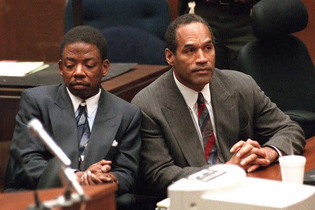 <p>MYUNG J. CHUN/AFP via Getty</p> O.J. Simpson (R) and defense attorney Carl Douglas (L) on Oct. 2, 1995.