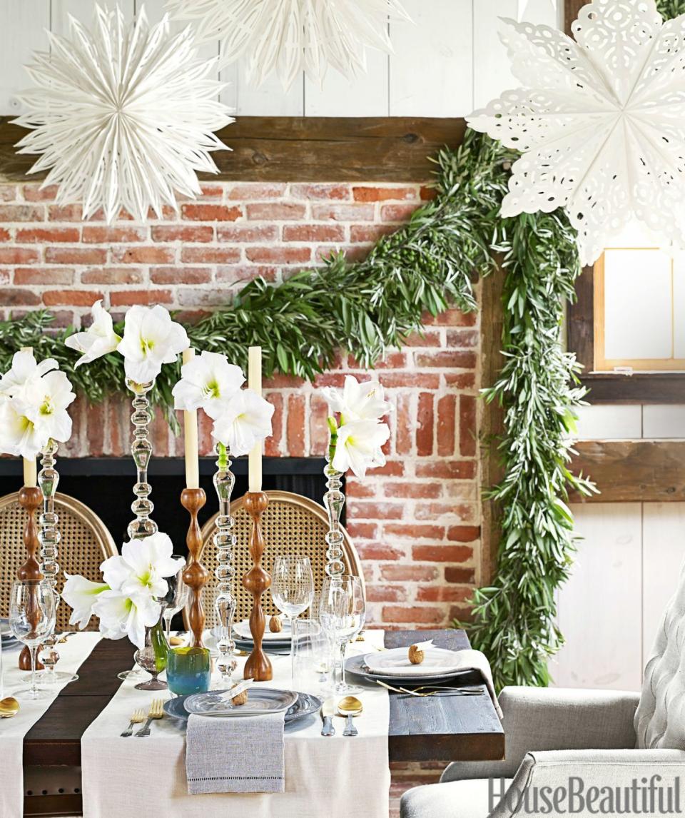 <p>Decorate using objects of different heights. Start by hanging oversized snowflakes, and building up the table with tall candlesticks. For the mantel, hang a garland made with olive branches.</p><p><a class="link " href="https://www.amazon.com/Candlestick-Set-Baluster-Pillar-Candlesticks/dp/B00F0RXMHQ/?tag=syn-yahoo-20&ascsubtag=%5Bartid%7C10057.g.790%5Bsrc%7Cyahoo-us" rel="nofollow noopener" target="_blank" data-ylk="slk:BUY NOW;elm:context_link;itc:0;sec:content-canvas">BUY NOW</a> <em><strong>Glass Candlesticks, $65, amazon.com</strong></em></p>