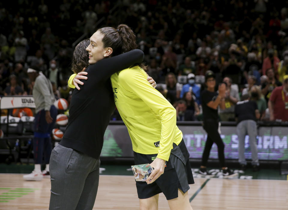 Seattle Storm general manager Talisa Rhea, left, hugs forward Breanna Stewart (30) after presenting Stewart with the WNBA Peak Performer Award as she is also honored as The Associated Press WNBA Player of the Year before Game 1 of a WNBA basketball first-round playoff series against the Washington Mystics Thursday, Aug. 18, 2022, in Seattle. (AP Photo/Lindsey Wasson)