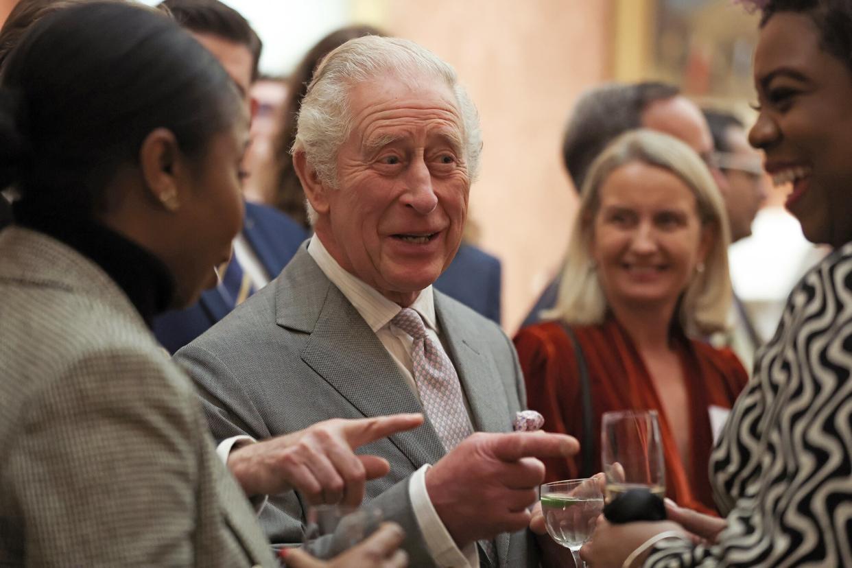 King Charles III speaks to guests during a reception to celebrate small and medium-sized businesses at Buckingham Palace on November 16, 2022 in London, England.