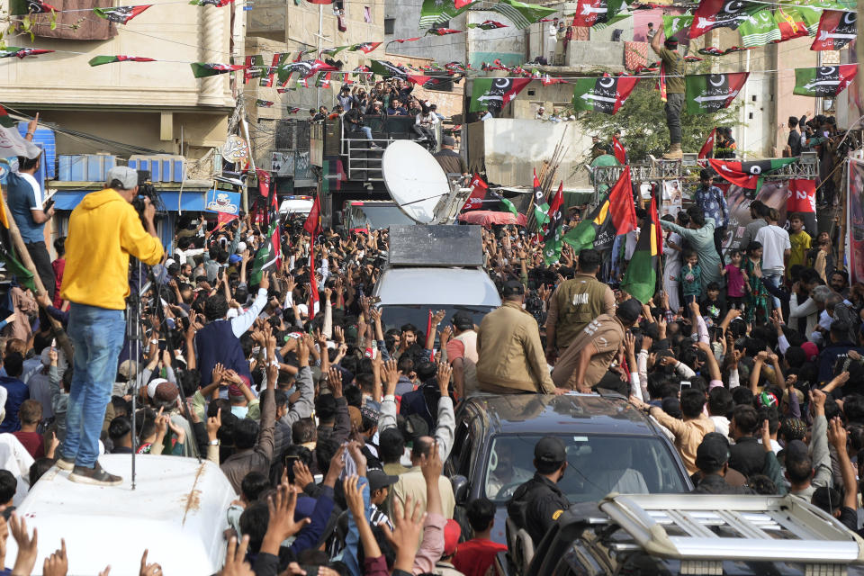 Supporters of Pakistan People's Party cheer party chairman Bilawal Bhutto Zardari, seen in blue shirt on the truck in the background, during an election campaign rally, in Karachi, Pakistan, Monday, Feb. 5, 2024. (AP Photo/Fareed Khan)