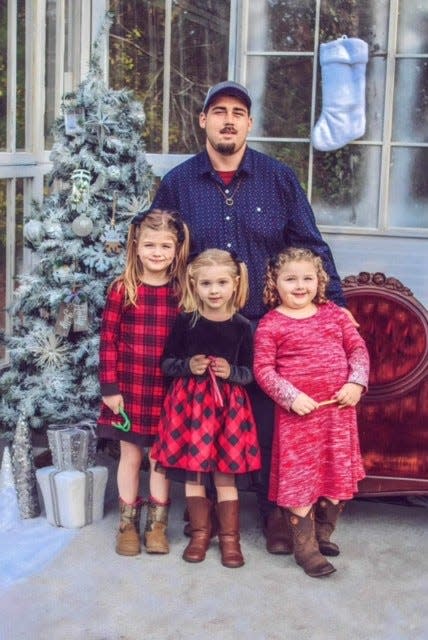 Dylan Bailey with his three daughters.