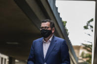 Premier of Victoria Daniel Andrews arrives for a news conference in Melbourne, Australia, Wednesday, Aug. 5, 2020. Victoria state, Australia's coronavirus hot spot, announced on Monday that businesses will be closed and scaled down in a bid to curb the spread of the virus. (AP Photo/Asanka Brendon Ratnayake)