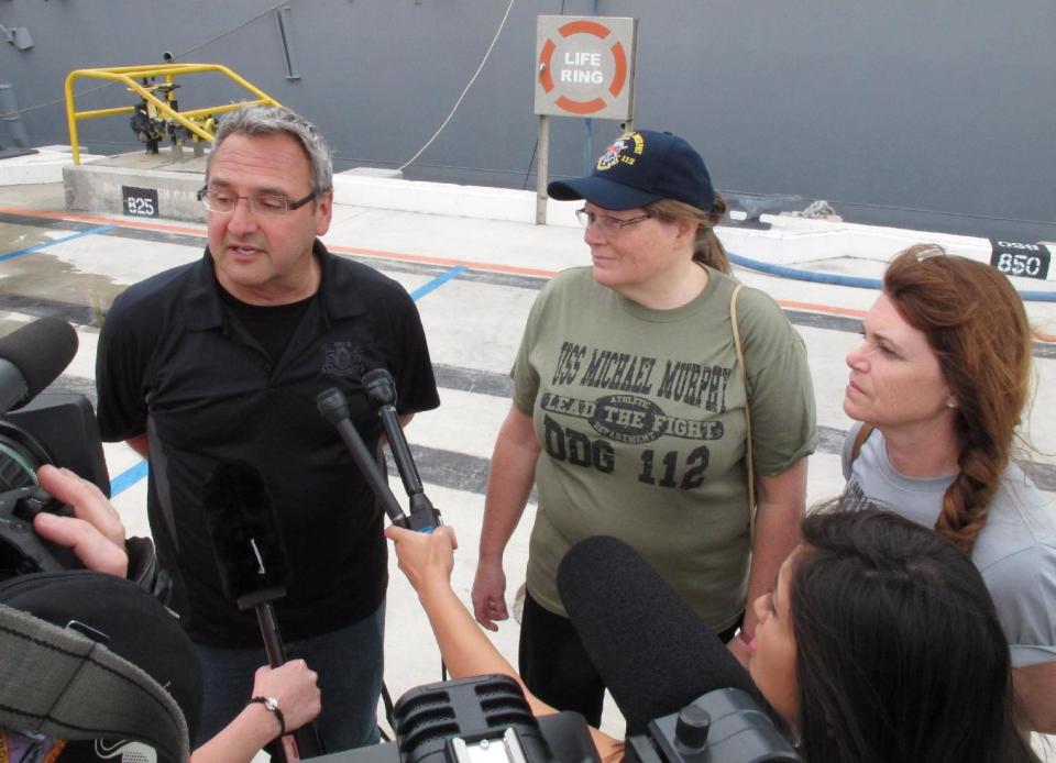 From left, passengers Wade Kehler, Arlene Veenhof and Susan Rossstrocel of a disabled Canadian naval ship speak with reporters after being escorted to Pearl Harbor, Hawaii on Tuesday, March 4, 2014. A U.S. Navy ocean tug was towing the Canadian ship after an engine fire left 20 sailors with minor injuries. (AP Photo/Oskar Garcia)