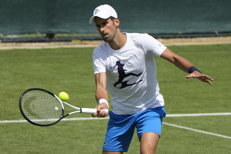 Serbia's Novak Djokovic plays a return as he practices ahead of the Wimbledon tennis championships in London, Sunday, June 26, 2022. (AP Photo/Alastair Grant)