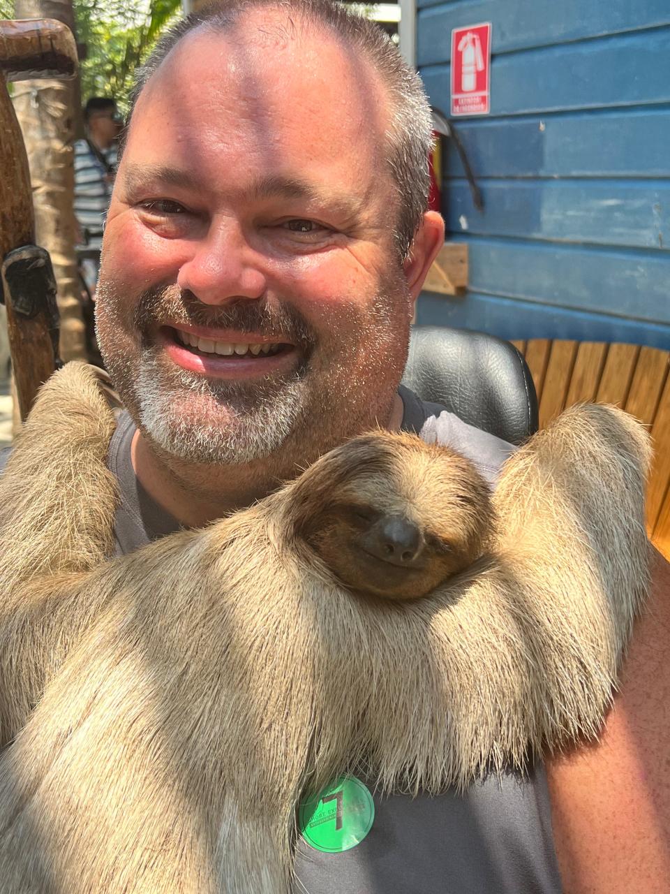 Chris Ricci with a sloth during a cruise stop in Honduras.