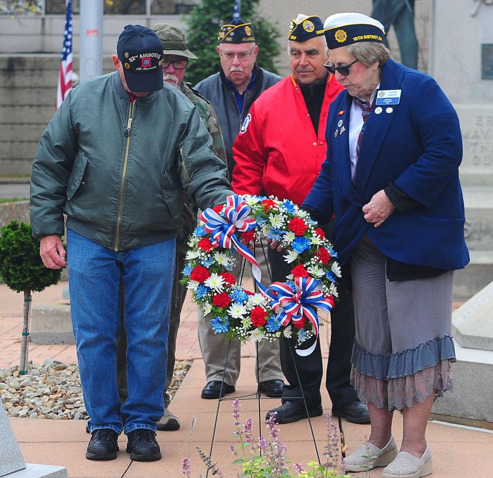 Veterans representing the various branches of the military place a wreath in front of memorial markers Saturday, Nov. 11, 2023, during a Veterans Day service at Freedom Square in downtown Alliance.