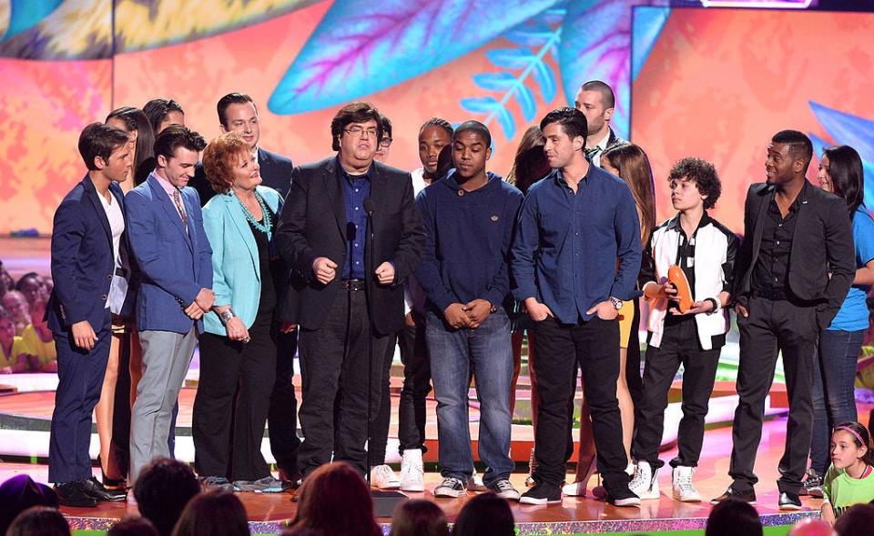 Writer/producer Dan Schneider accepts the Lifetime Achievement Award onstage with actors from his shows during Nickelodeon's 27th Annual Kids' Choice Awards on March 29, 2014.