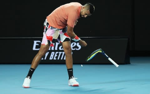 Kyrgios takes out his frustration on his racket - Credit: GETTY IMAGES