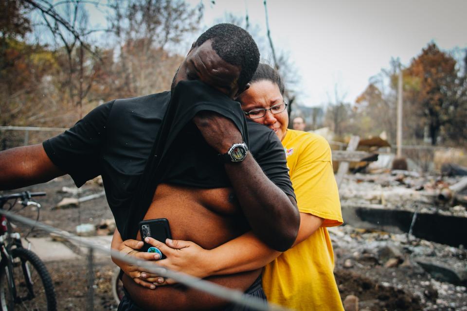 Emmanuel McComb cries as he is held by his wife, Jessica, as she sobs too on Monday, Oct. 24, 2022, in Wooldridge. Their home was destroyed by a wildfire that engulfed the small town. They lost a dog and two doves to the blaze.