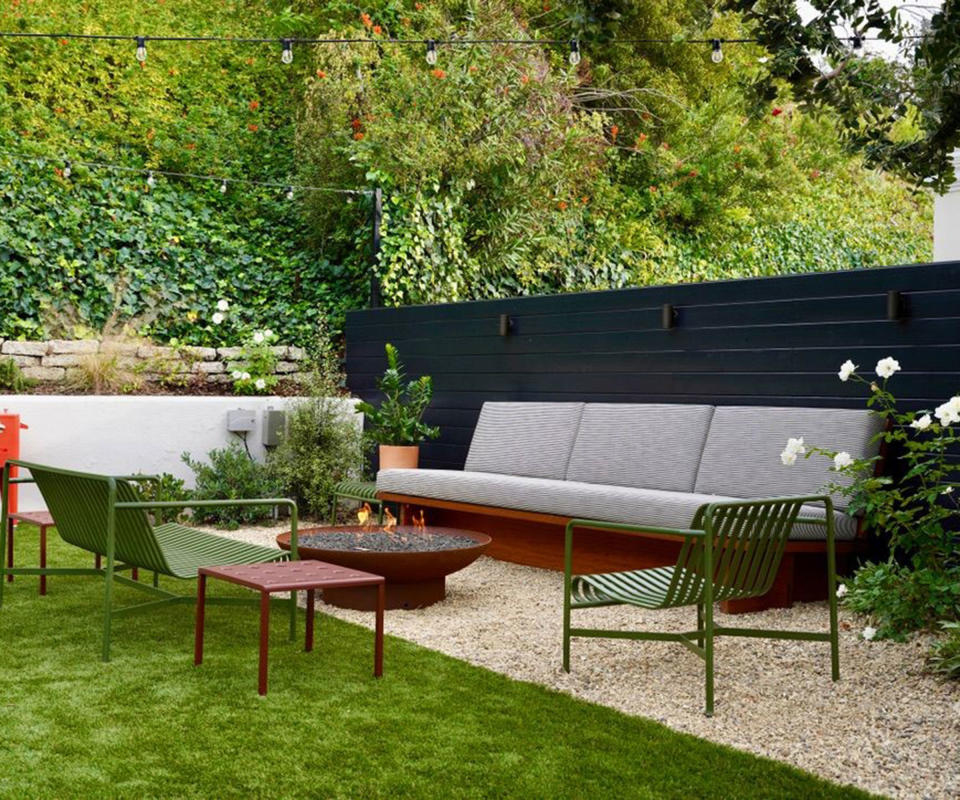 gravel patio area with seating and a fire pit