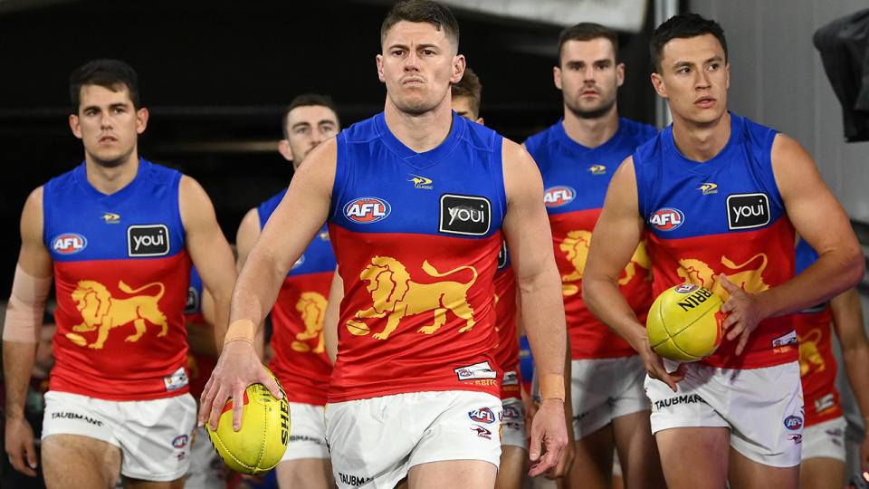 Dayne Zorko leads the Brisbane Lions onto the field for an AFL match in 2022.