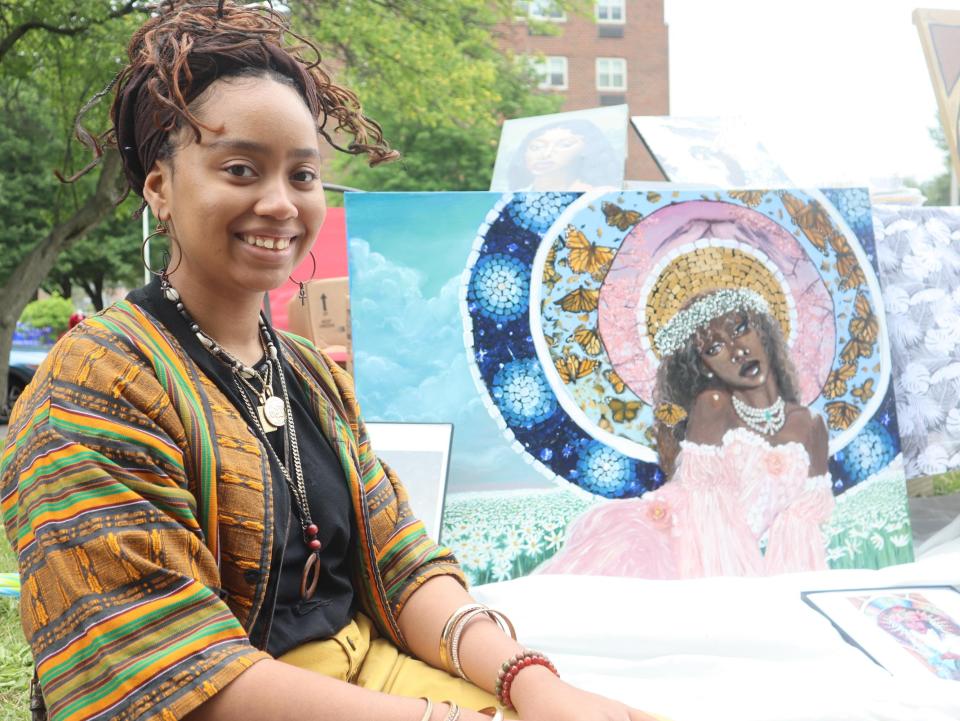 Surayya Muhammad, 17 of Utica, sells prints of her artwork at Utica's Juneteenth Celebration Saturday, June 18, 2022 at Chancellor Park.