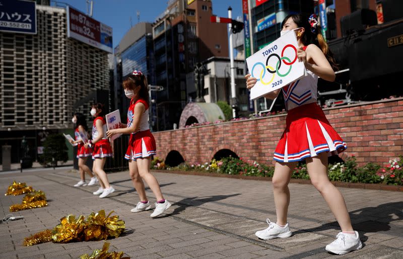 Cheerleaders perform at Shimbashi Station one day before Tokyo 2020 Olympics
