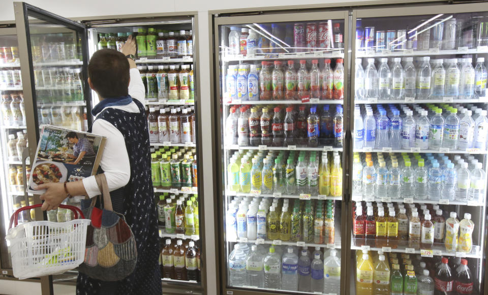 In this June 17, 2019, photo, plastic-bottled soft drinks are displayed in fridges at a Seven-Eleven store in Yokohama, near Tokyo. Japan has a plastic problem. Single bananas here are sometimes wrapped in plastic. So are individual pieces of vegetables, fruit, pastries, pens and cosmetics. Plastic-wrapped plastic spoons come with every ice cream cup. (AP Photo/Koji Sasahara)