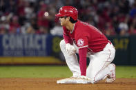 Los Angeles Angels designated hitter Shohei Ohtani kneels on second base after advancing from first on a single by Phil Gosselin during the third inning of a baseball game against the Seattle Mariners Saturday, Sept. 25, 2021, in Anaheim, Calif. (AP Photo/Mark J. Terrill)