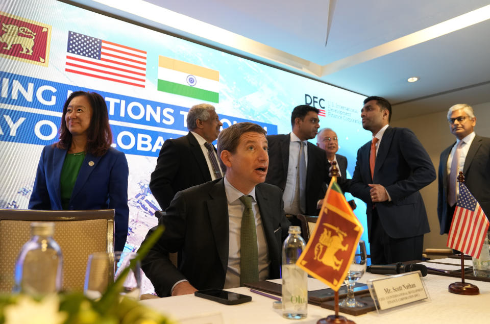 U.S. International Development Finance Corporation (DFC) Chief Executive Officer Scott Nathan, sitting, prepares to leave after making a statement in Colombo, Sri Lanka, Wednesday, Nov.8, 2023. The U.S. announced a $553- million project Wednesday to build a new, deep-water shipping container terminal in the Port of Colombo as it competes with China in international development financing. (AP Photo/Eranga Jayawardena)