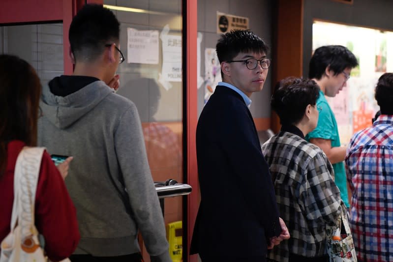 Disqualified candidate and pro-democracy activist Joshua Wong stands in line to vote in the district council elections in Hong Kong