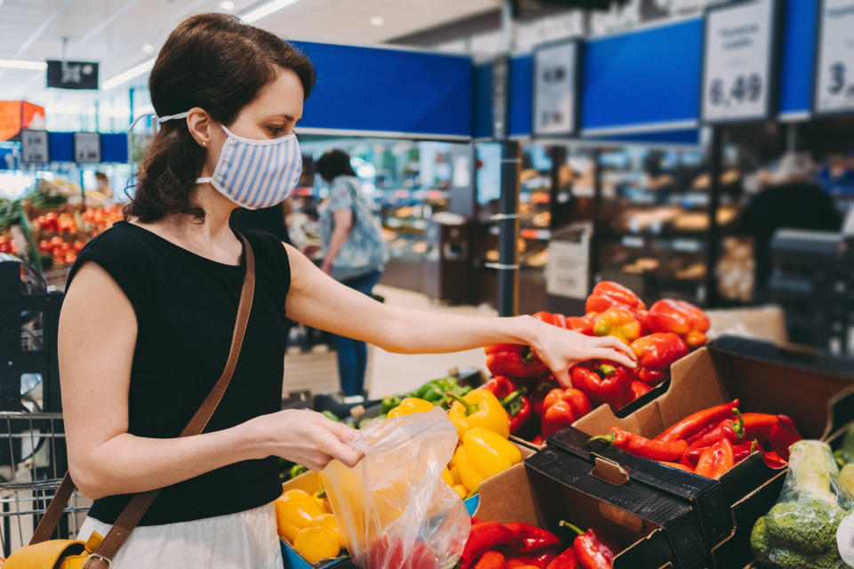 Woman in grocery shopping during COVID-19. Credit: Getty.