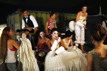 Cast members wait backstage in between acts during a dress rehearsal of Giuseppe Verdi's opera "La Traviata" at the foothill of Masada, an ancient Jewish mountaintop fortress near the Dead Sea in southeast Israel June 10, 2014. REUTERS/Amir Cohen