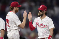 Philadelphia Phillies' Bryce Harper, right, and Spencer Turnbull celebrate after the Phillies won a baseball game against the Toronto Blue Jays, Tuesday, May 7, 2024, in Philadelphia. (AP Photo/Matt Slocum)