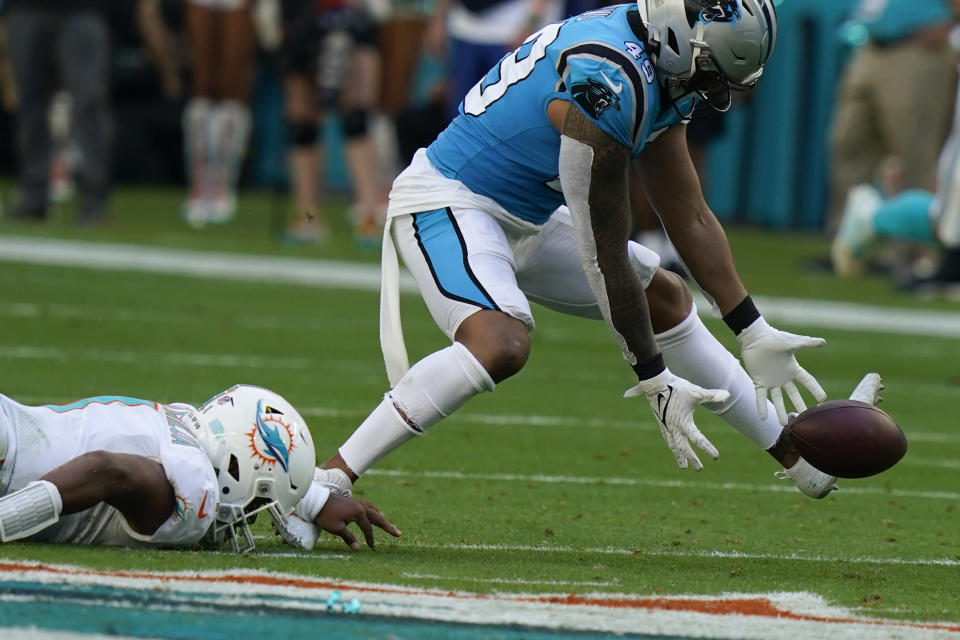 Carolina Panthers outside linebacker Frankie Luvu (49) recovers a fumble past Miami Dolphins quarterback Tua Tagovailoa (1) as the Panthers go on to score a field goal during the first half of an NFL football game, Sunday, Nov. 28, 2021, in Miami Gardens, Fla. (AP Photo/Lynne Sladky)