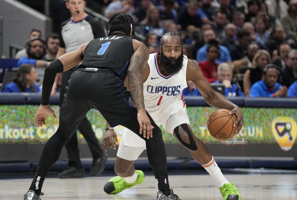 Los Angeles Clippers guard James Harden (1) dribbles against Dallas Mavericks guard Jaden Hardy (1) during the first half of an NBA basketball game in Dallas, Wednesday, Dec. 20, 2023. (AP Photo/LM Otero)