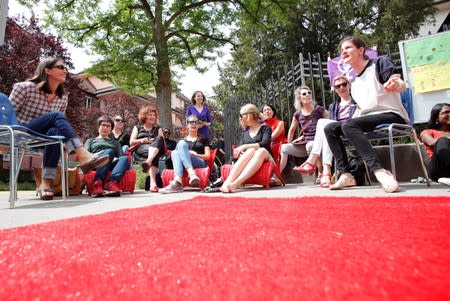 Teachers and mothers of pupils take part in a strike in front of the Aemtler school in Zurich