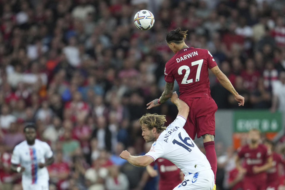 Liverpool's Darwin Nunez, top, heads the ball past Crystal Palace's Joachim Andersen during the English Premier League soccer match between Liverpool and Crystal Palace at Anfield stadium in Liverpool, England, Monday, Aug. 15, 2022. (AP Photo/Jon Super)